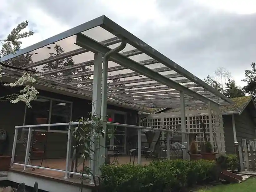 Polycarbonate cover over a deck with glass railing