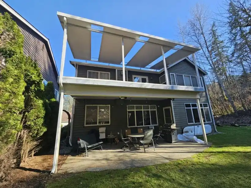 White aluminum covers over the upper and lower decks of a two-storey house