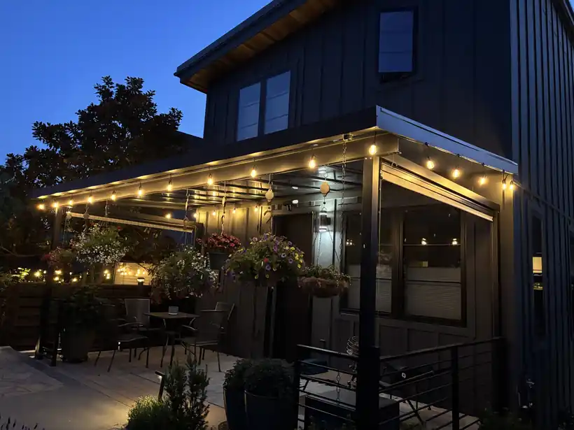 Covered deck with string lights glowing at night